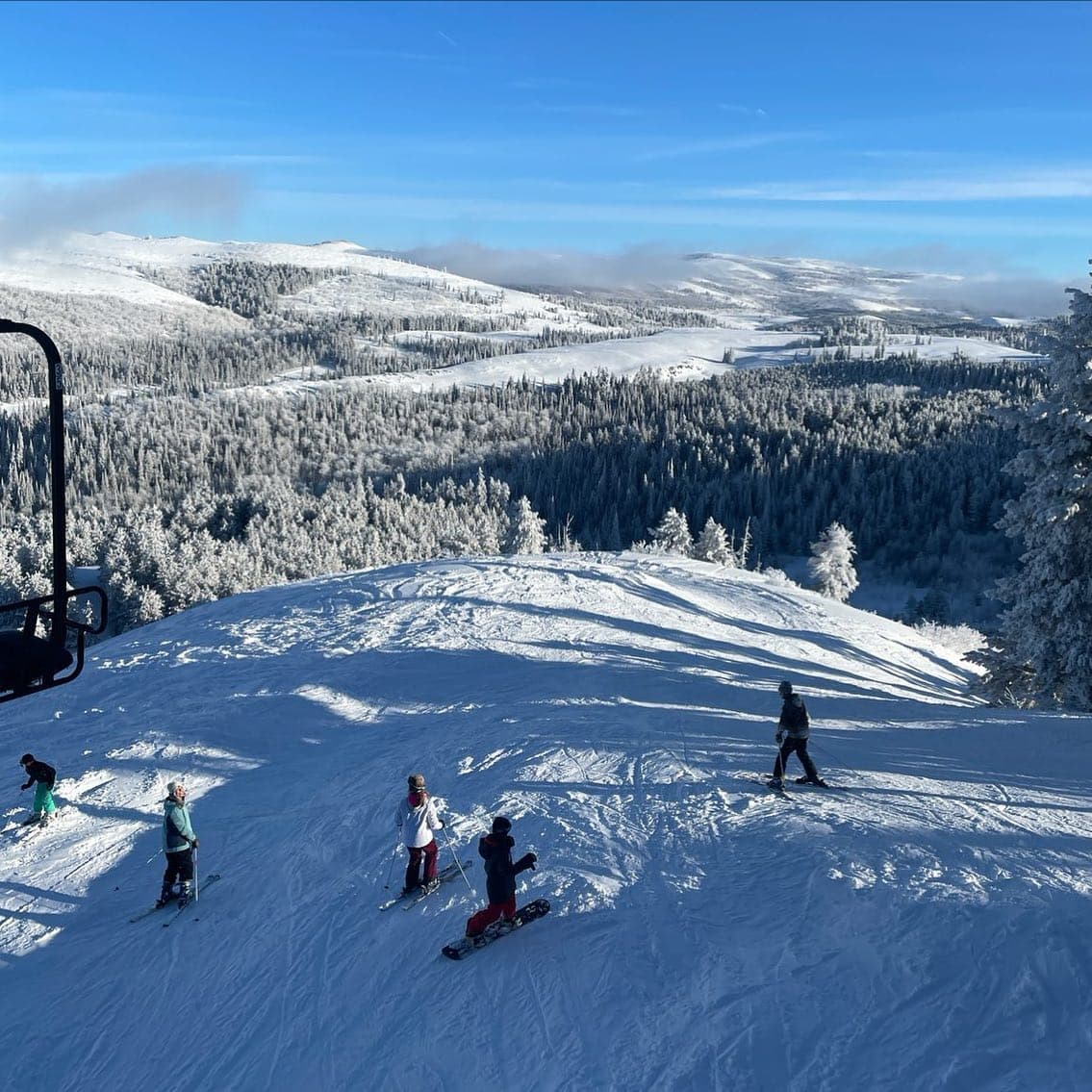 Magic Mountain in USA - a group of people skiing down a snow covered mountain.