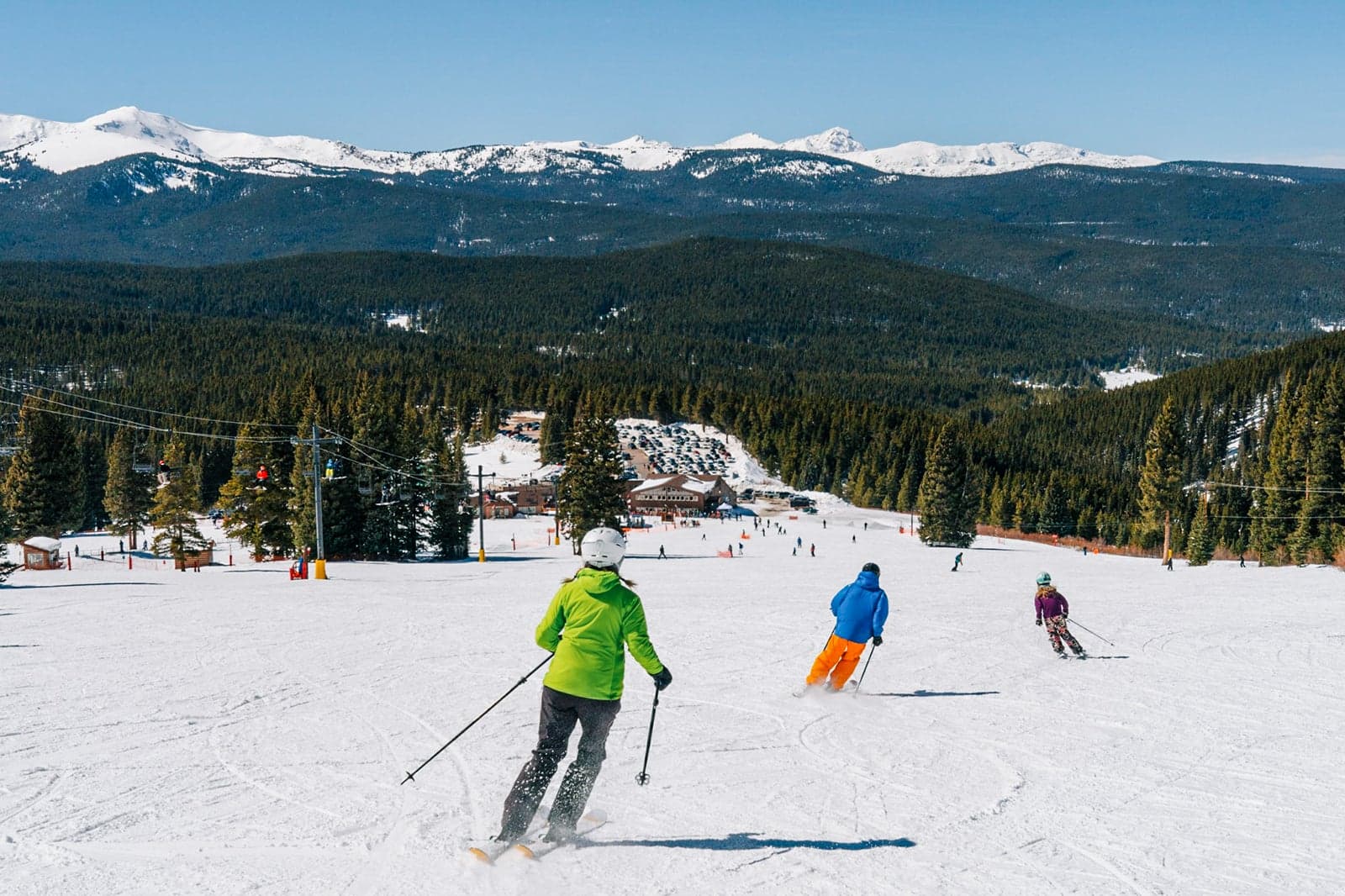 Cooper in USA - a group of people skiing down a snowy slope.