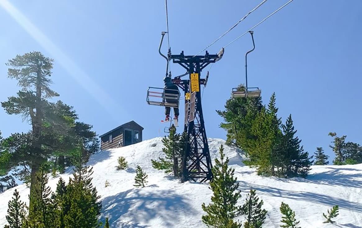 Mt Baldy in USA - a ski lift going up a snowy hill.