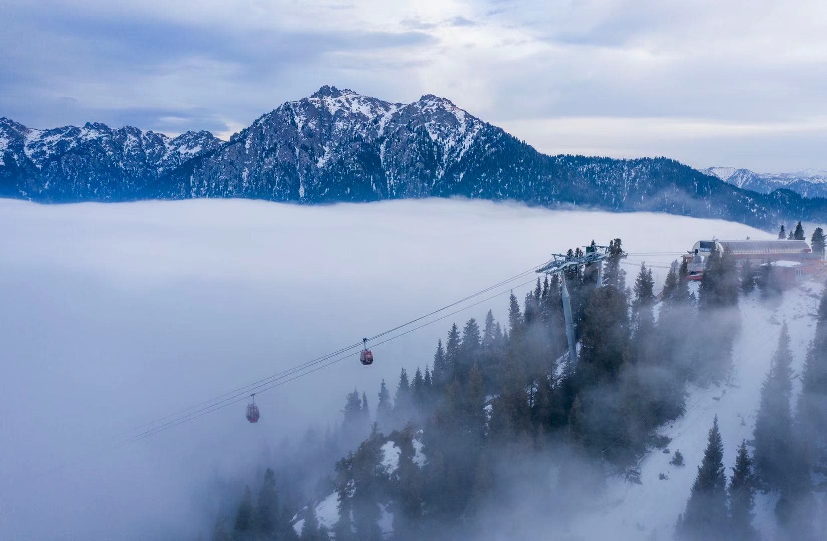 SilkRoad Ski in China - a cable car in the middle of a snowy mountain.